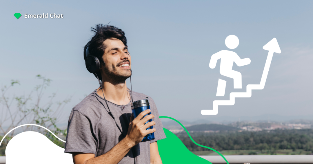 A man outdoors smiling with headphones on and holding a drink, with an icon of a person climbing steps symbolizing growth and progress.