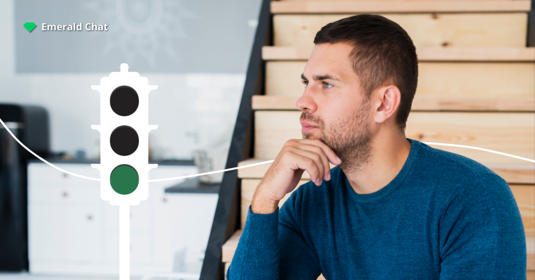 Man sitting and thinking deeply, reflecting on whether to act when falling for someone you barely talk to