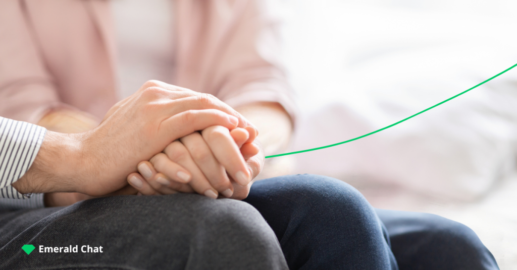 image of someone's hand holding another hand in comfort