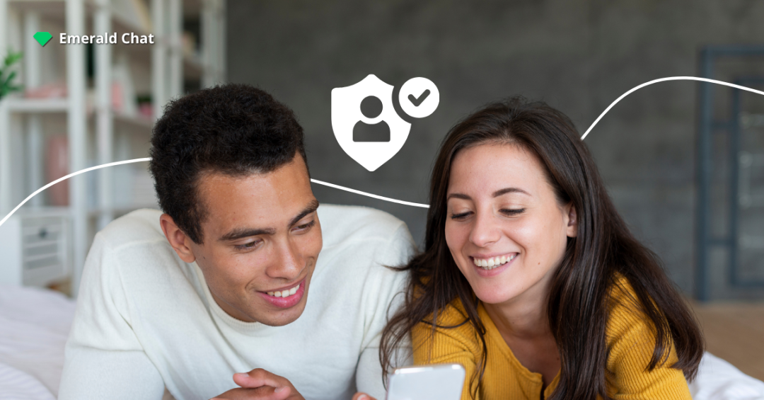 A happy couple lying on a bed and looking at a phone together, with a shield and user verification icon symbolizing online trust and AI moderation safety.